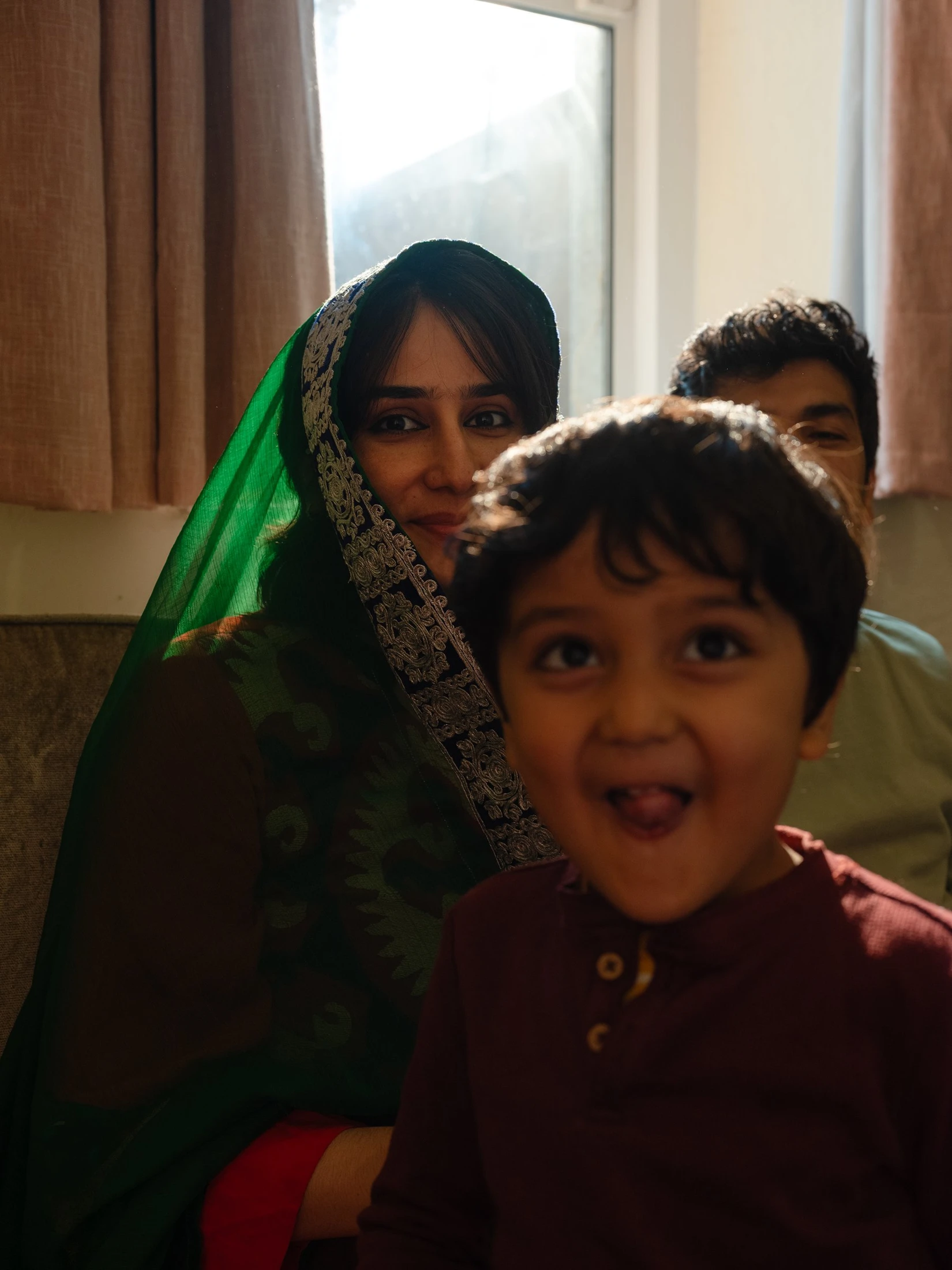 A family photographed together by a window, from the Farid series