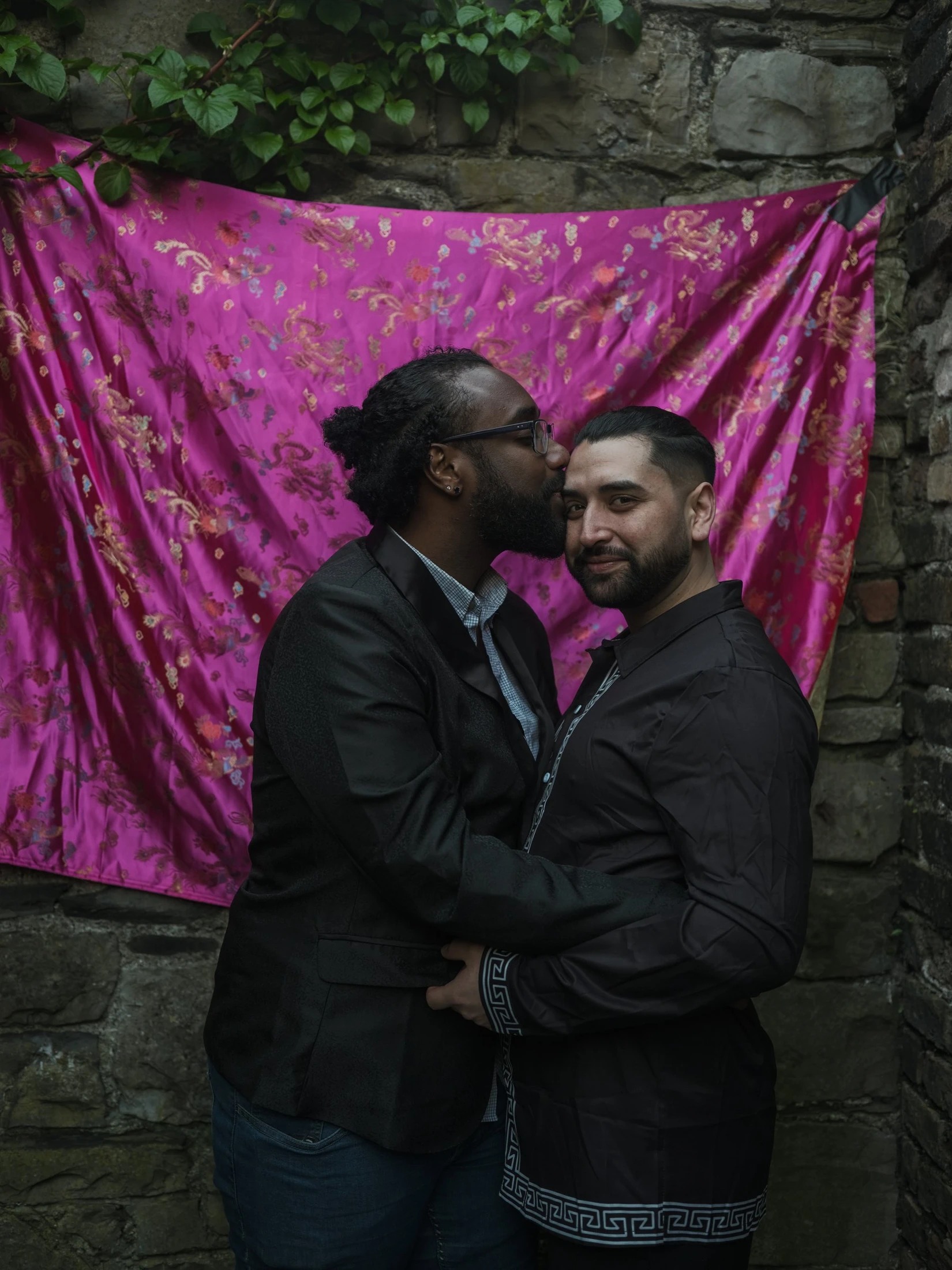 Pedro and Pablo together in front of magenta fabric