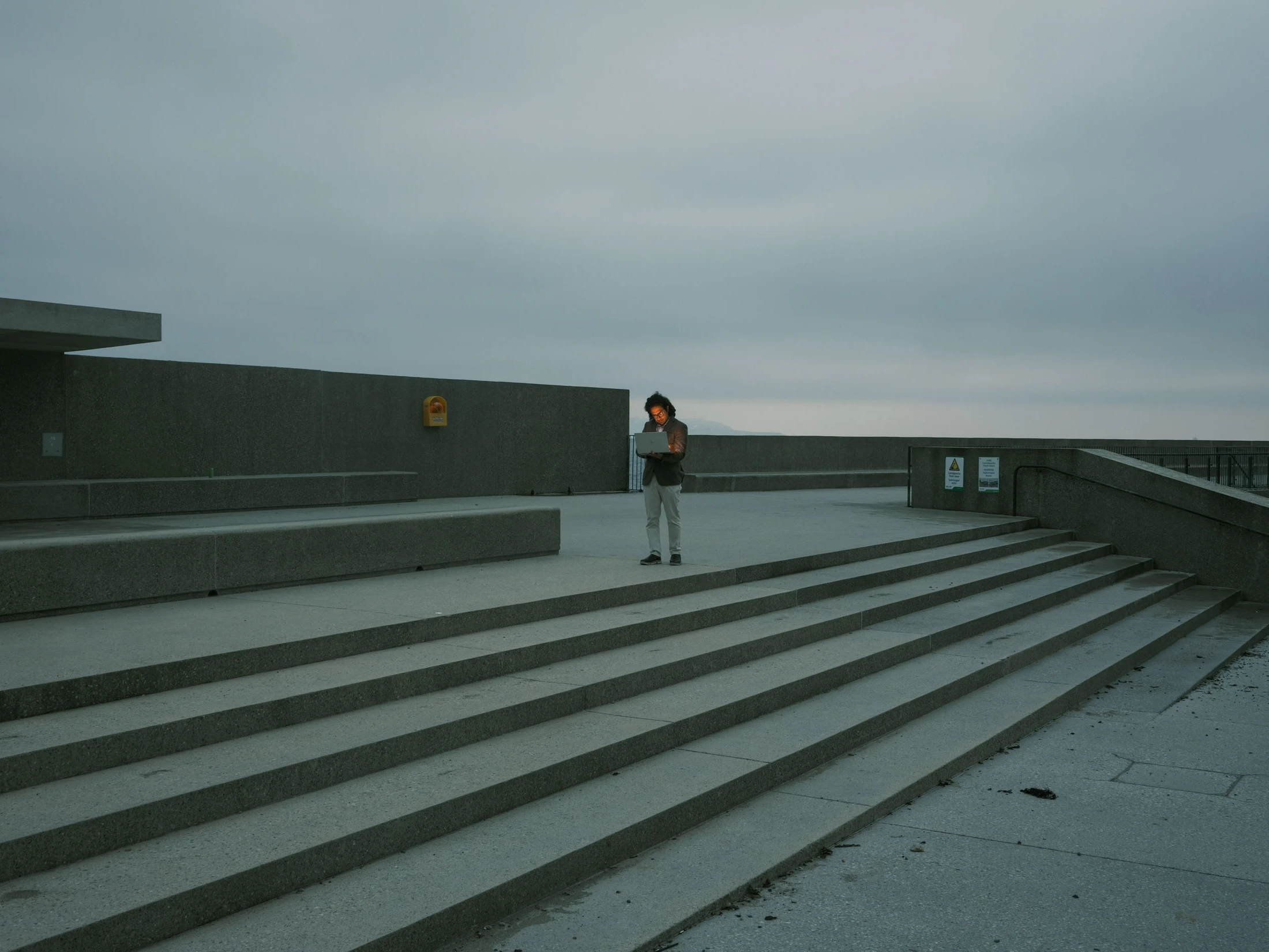 Saeedullah standing on broad steps overlooking the sea