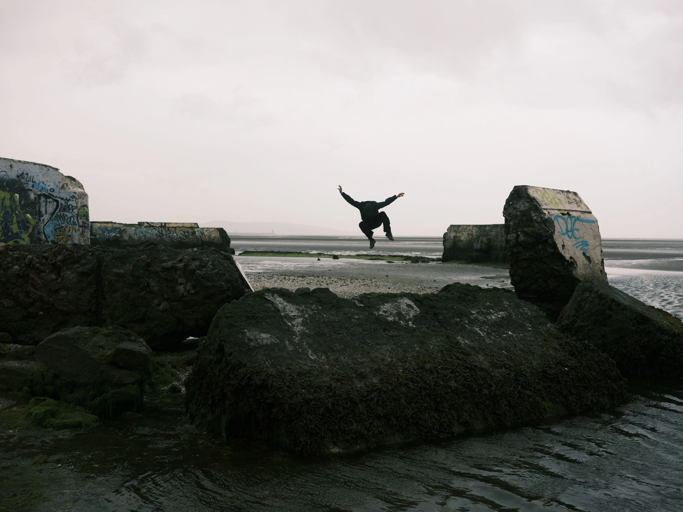 Salah leaping between two seawalls